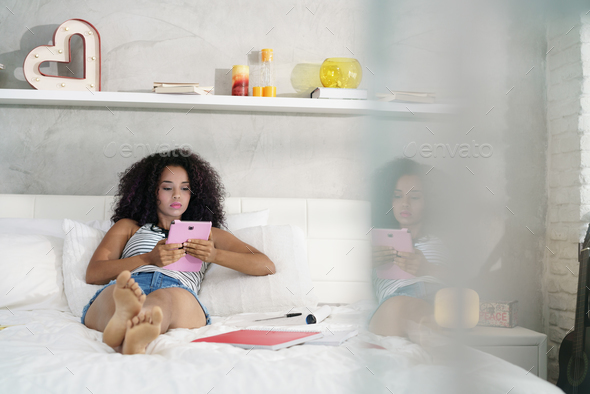 Hispanic Girl Using Digital Tablet For School Homework - Stock Photo - Images
