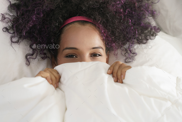 Beautiful Happy Hispanic Teen Waking Up And Smiling Undercover - Stock Photo - Images