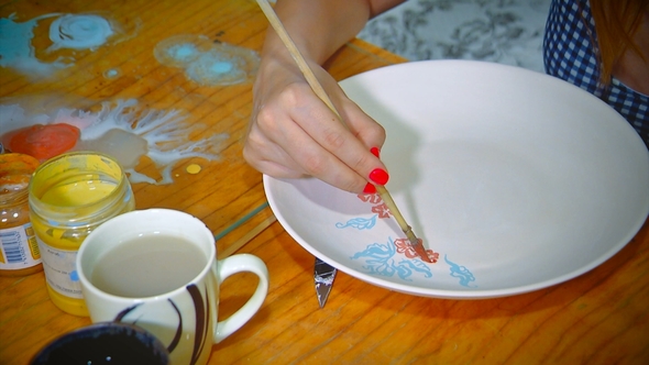 Pretty Young Woman Potter Paints a Clay Plates. Woman Working In Her Pottery Studio. Small Business alt