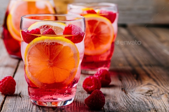 Sparkling Lemon Raspberry Lemonade Sangria in glass on wooden background - Stock Photo - Images