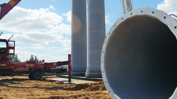 Worker Controls Pipe Shape Tower Installation with Car Cranes alt