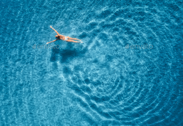 Aerial view of swimming woman in mediterranean sea - Stock Photo - Images