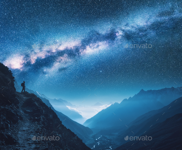 Space with Milky Way, girl and mountains at night - Stock Photo - Images