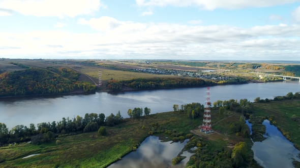 Steel Lattice Towers Support Overhead Power Line Near River alt