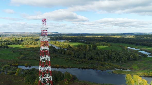 Tower Carries Electric Conductors Against Green Landscape alt