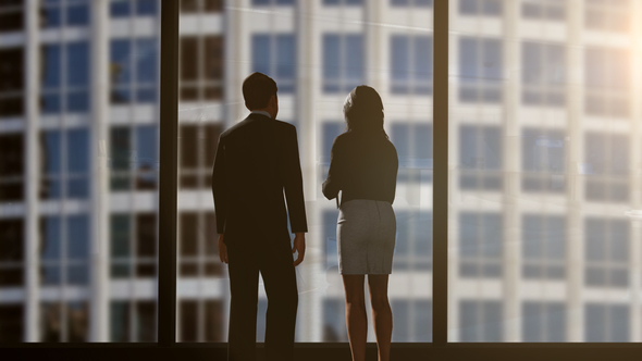 Silhouettes Of Two Business Partners