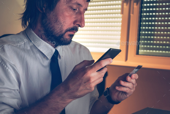 Businessman using mobile banking services app to purchase online - Stock Photo - Images