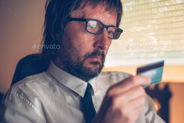 Businessman shopping online with debit payment card - Stock Photo - Images