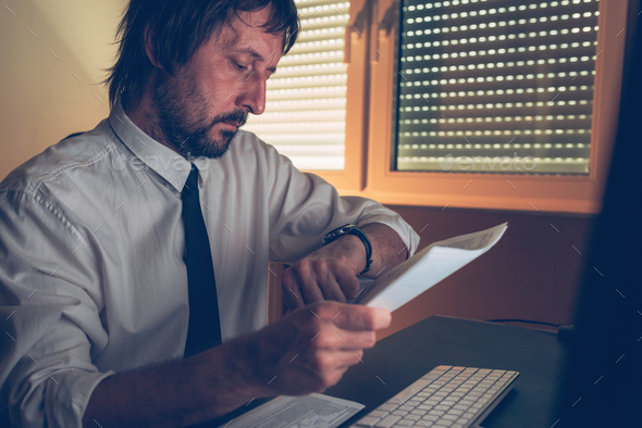 Businessman checking time on his wristwatch - Stock Photo - Images