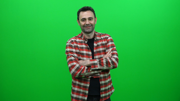 Young Man Crossing Arms on Green Screen