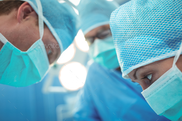 Team of surgeons performing operation in operation theater Stock Photo by Wavebreakmedia