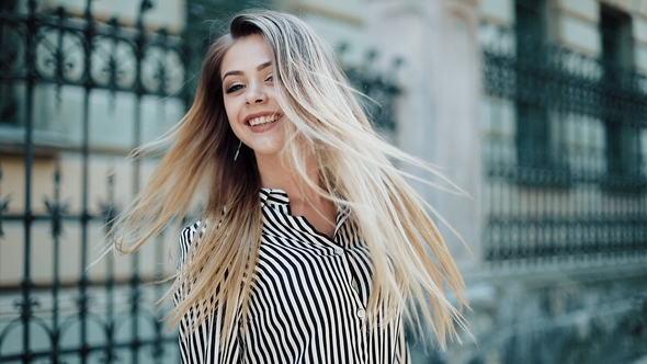 Happy Beautiful Businesswoman in the Beautiful Dress Walking Along the Old Street