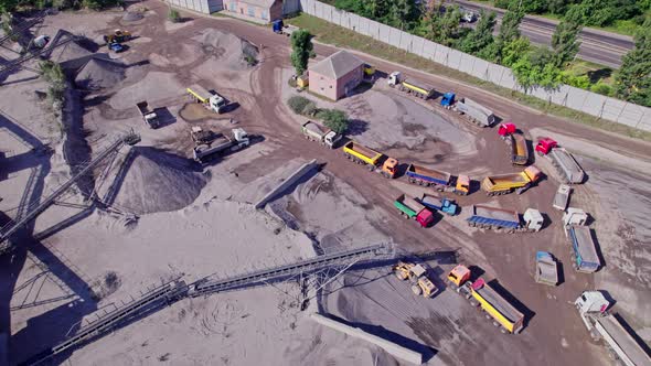 The Excavator Loads the Crushed Stone in a Truck alt