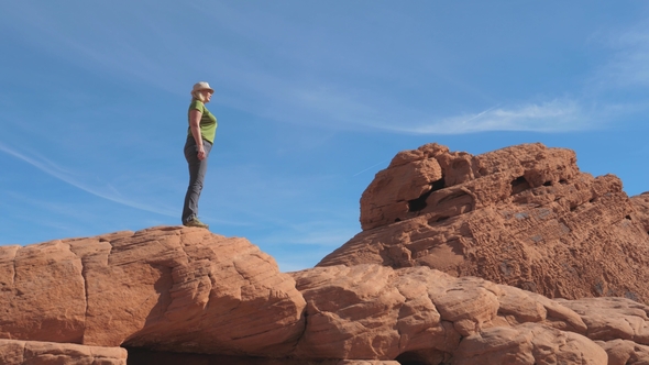Side View A Active Woman Climbs The Red Rocks Up Background The Sky