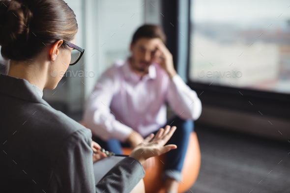 Counselor interacting with unhappy man - Stock Photo - Images