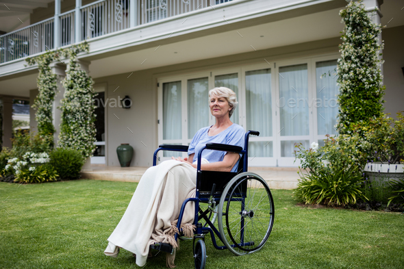 Thoughtful Senior Woman Sitting On Wheelchair Stock Photo By Wavebreakmedia