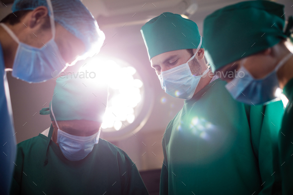 Medical team performing operation in operating room - Stock Photo - Images