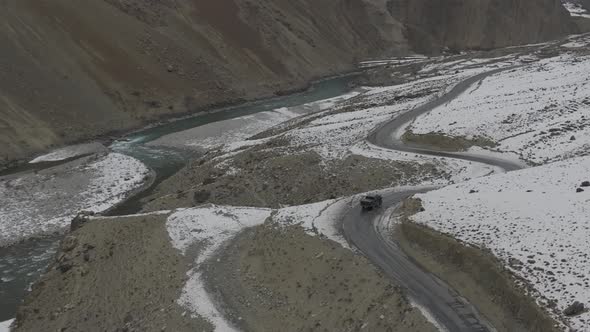 Aerial Over Turquoise Colour River Water In Hunza Valley. Dolly front Tilt Down Shot. alt