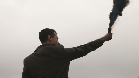 Serious Man Holding Smoke Bomb with Black Fume