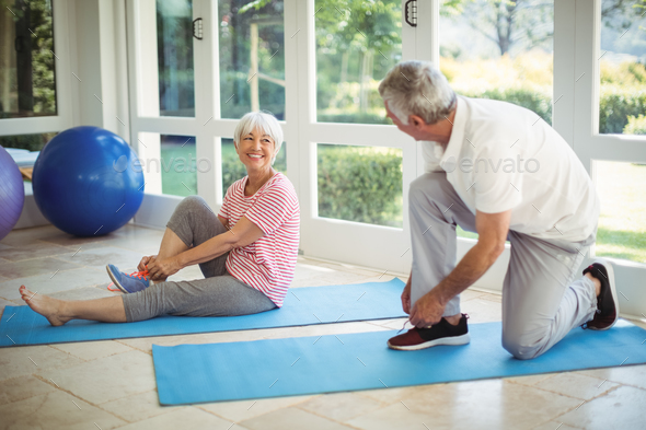 Senior couple removing their shoes at home Stock Photo by Wavebreakmedia