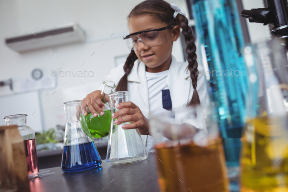 Elementary student doing scientific experiment at laboratory Stock ...