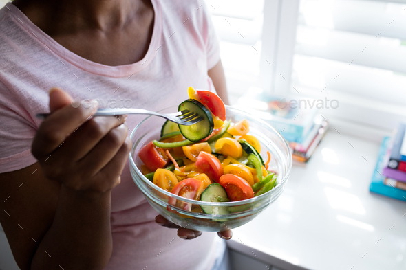 Mid section of woman having salad Stock Photo by Wavebreakmedia | PhotoDune
