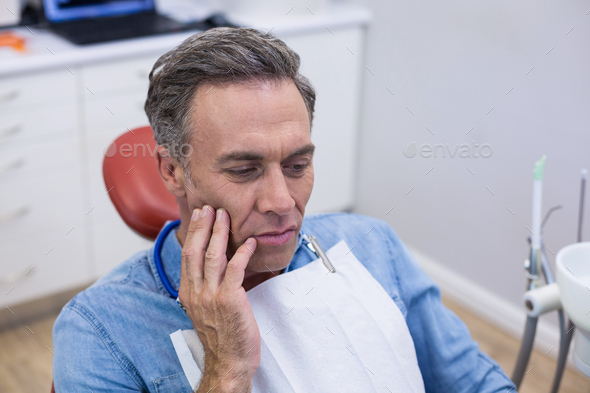Unhappy man having a toothache - Stock Photo - Images