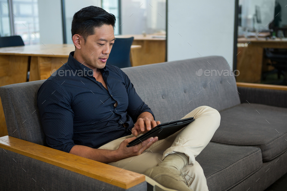 Business executive using digital tablet Stock Photo by Wavebreakmedia