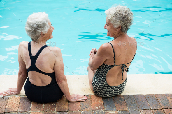 Senior women interacting with each other while relaxing Stock Photo by Wavebreakmedia