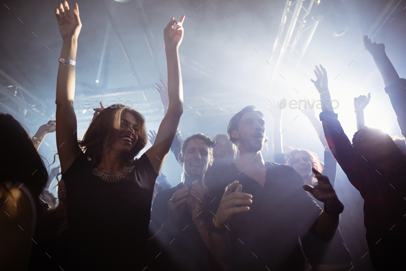 Happy people dancing at nightclub Stock Photo by Wavebreakmedia | PhotoDune