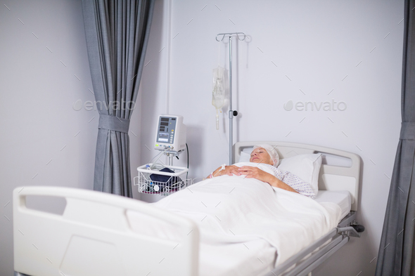 Senior woman patient sleeping on bed Stock Photo by Wavebreakmedia