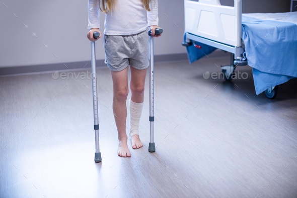 Girl walking with crutches in ward Stock Photo by Wavebreakmedia | PhotoDune