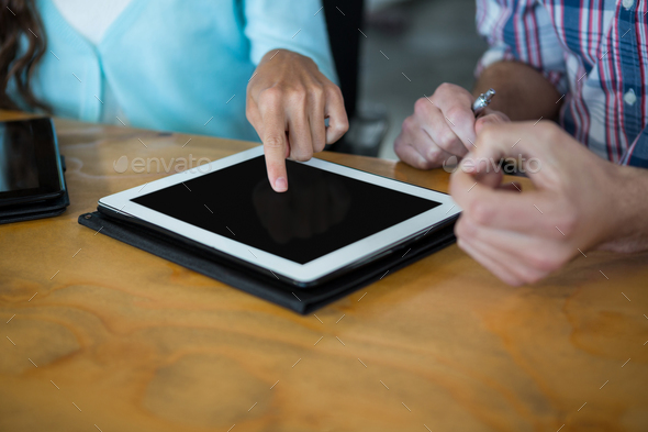 Business executives using digital tablet at desk Stock Photo by Wavebreakmedia