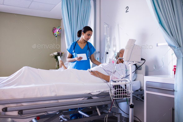 Female doctor consoling female senior patient Stock Photo by Wavebreakmedia