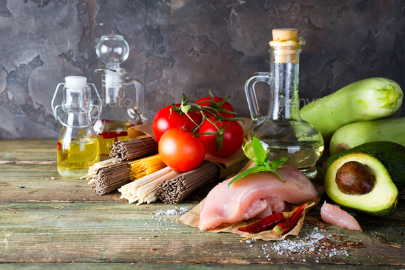 bunch of Italian spaghetti, noodles soba and sommel, chicken raw meat, avocado, zucchini with tomato - Stock Photo - Images