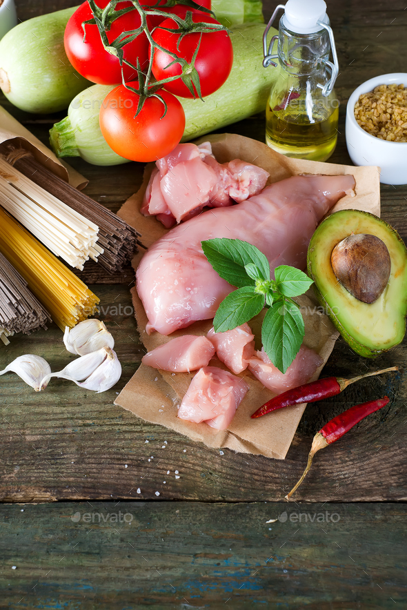 bunch of Italian spaghetti, noodles soba and sommel, chicken raw meat, avocado, zucchini with tomato - Stock Photo - Images