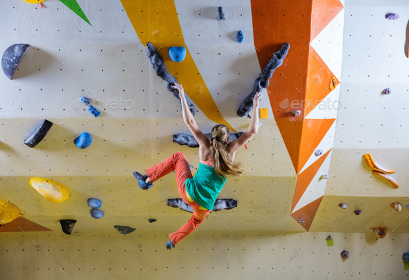 Young woman falling down while bouldering in climbing gym Stock Photo ...