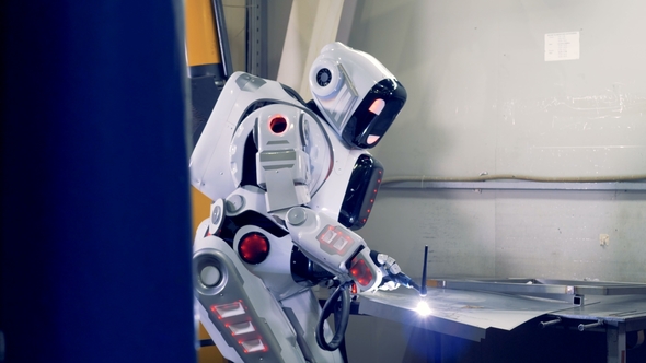 Welding Process of a Metal Sheet Performed By a Humanlike Robot at a Factory Floor alt