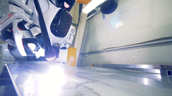 Metal Sheet Getting Welded By a Industrial Robot alt
