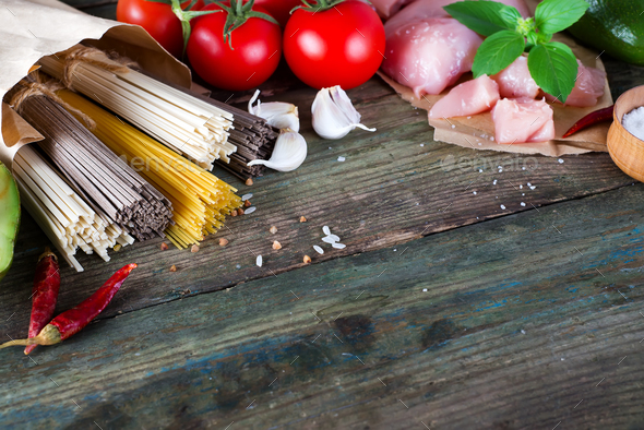 bunch of Italian spaghetti, noodles soba and sommel, chicken raw meat, avocado, zucchini with tomato - Stock Photo - Images