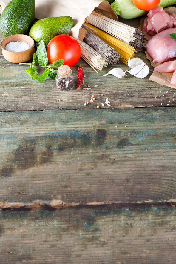 bunch of Italian spaghetti, noodles soba and sommel, chicken raw meat, avocado, zucchini with tomato - Stock Photo - Images