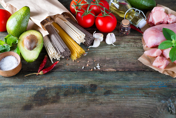 bunch of Italian spaghetti, noodles soba and sommel, chicken raw meat, avocado, zucchini with tomato - Stock Photo - Images