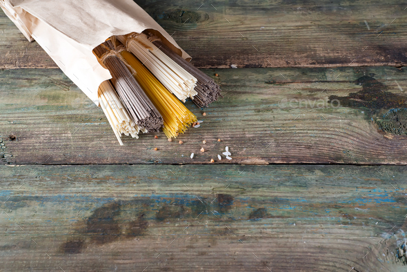 Noodles soba, somen and italian spaghetti on wooden background. Traditional Japanese food. - Stock Photo - Images