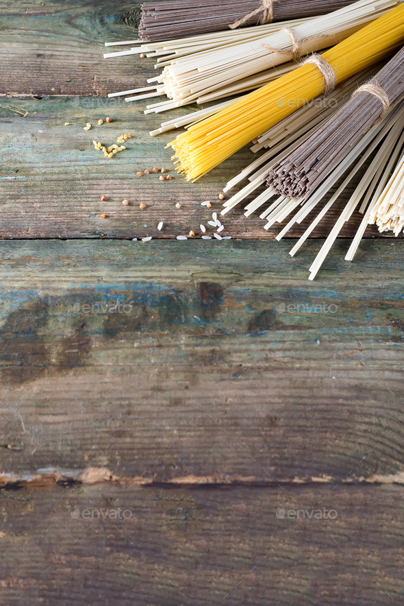 Noodles soba, somen and italian spaghetti on wooden background. Traditional Japanese food. - Stock Photo - Images