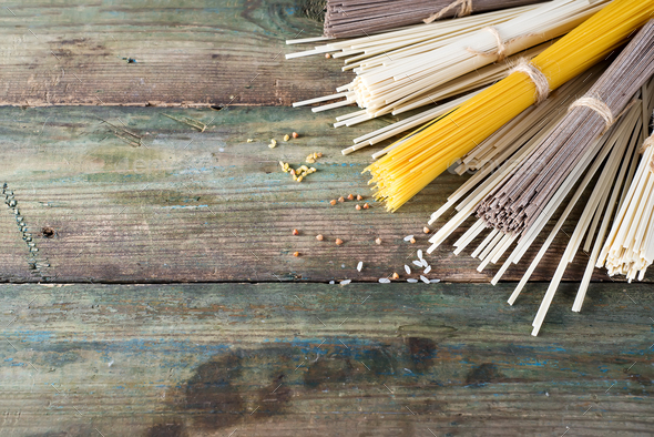 Noodles soba, somen and italian spaghetti on wooden background. Traditional Japanese food. - Stock Photo - Images