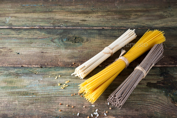 Noodles soba, somen and italian spaghetti on wooden background. Traditional Japanese food. - Stock Photo - Images