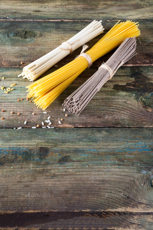 Noodles soba, somen and italian spaghetti on wooden background. Traditional Japanese food. - Stock Photo - Images