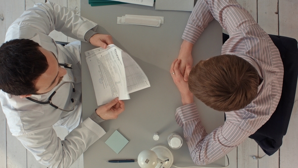 Doctor Discussing a Patient's Results. Top View alt
