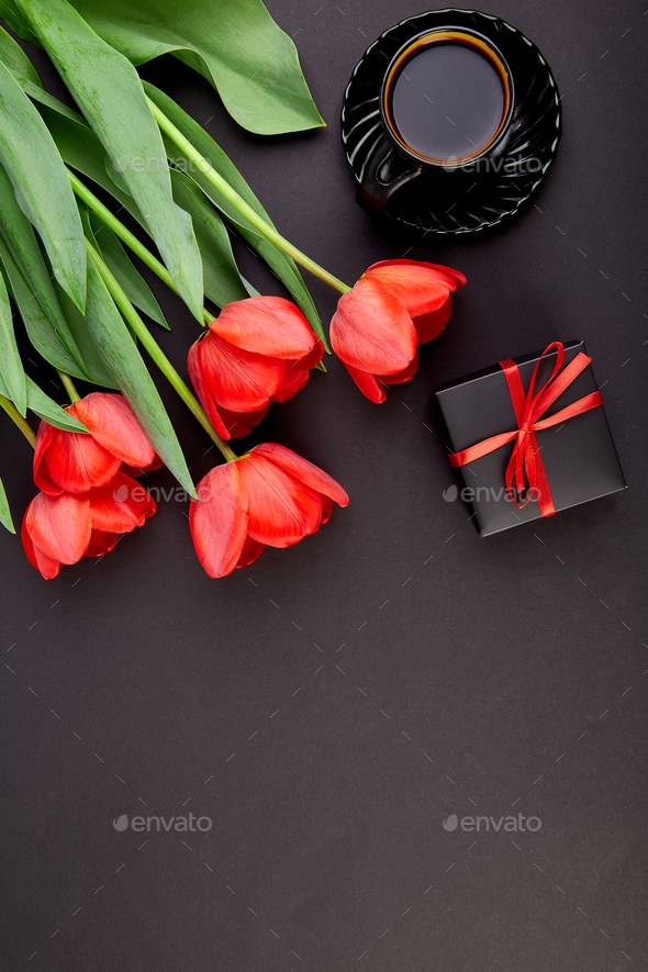 Bouquet red tulips and cup of coffee - Stock Photo - Images