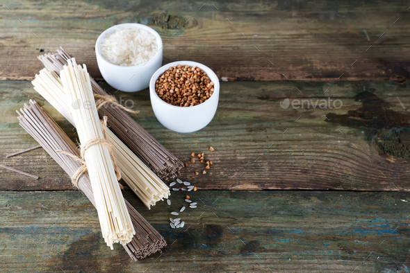 noodles soba and sommel, bowls with buckwheat and rice on an old wooden background - Stock Photo - Images